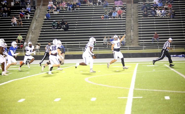Jerrell Sims (left) returns a fumble for a touchdown on the opening play of Elbert’s game at Banks County on Oct. 10. (Photo by Bo Underwood)