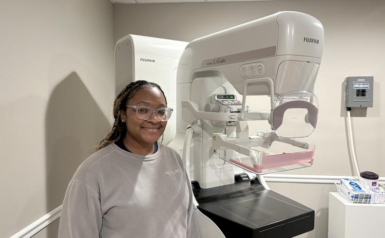 Mammography technician Alayjah Sammons poses with the Fujifilm ASPIRE Cristalle, a state-of-the-art mammography machine that is available for patients at Elbert Memorial Hospital.