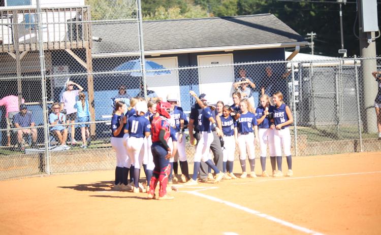 Kamryn Webb (26) crosses the plate and celebrates with teammates after hitting a home run in Elbert’s 15-0 win over Putnam County on Oct. 15. (Photo by Bo Underwood)