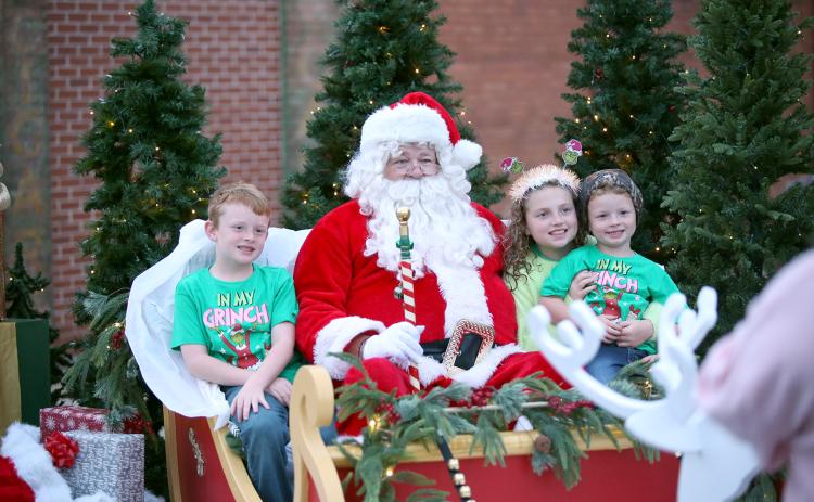 Children sit with Santa at Elberton's Candlelight Shop Night on Nov. 25. (Photo by Mark Wells)