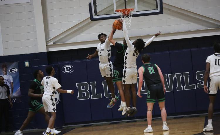 D.K. Winn (3) and Blu Hester (20) block a shot.  (Photo by Bo Underwood)