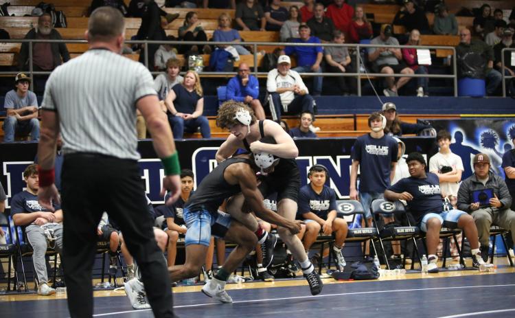 Jayden Thompson shoots for a doubleleg takedown in a match against Olgethorpe County. (File photo by Mark Wells)
