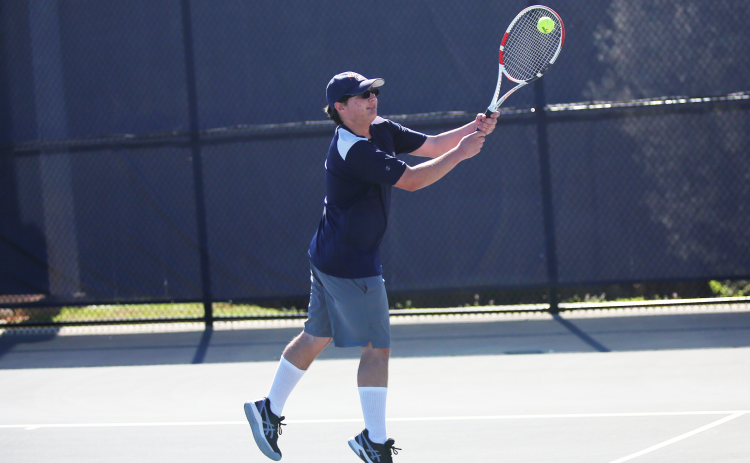 Adrian Jenkins returns a serve with two hands. (Photo by Bo Underwood)