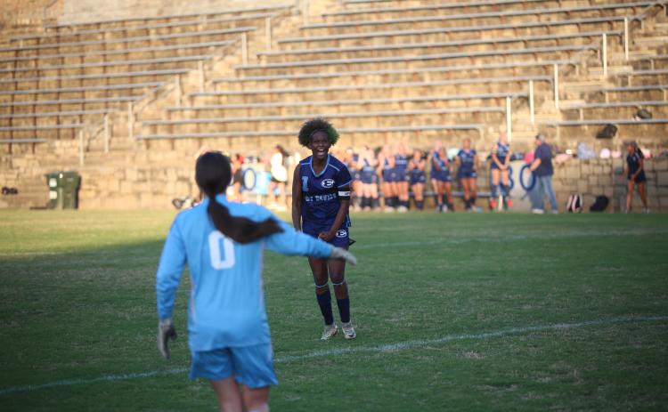 County senior Promouz Goodman celebrates after making the game-winning penalty kick. (Photo by Bo Underwood)