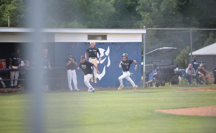 Elbert County head coach Lance Ingram (left) runs alongside shortstop Brayden Ingram (1) after sending him home as Jackson Black (7) celebrates. (Photo by Bo Underwood)