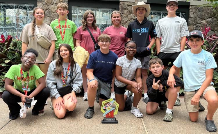 The Elbert County Middle School Beta Club won two awards at the national convention in Nashville, Tennesee last week. Above, the club poses with their 10th-place Project Proposal trophy. Club members include (front row, L-R) Alyssa Handy, Sophie Black, Landon Hulme, Myla Hood, Michael Evans, Klay Hall and (back row, L-R) Claire Moon, Monroe Ray, Lizzy Sigman, Reece Oakley, Levi Wiles and Kale Hall. (Photo courtesy of Marie Roach)