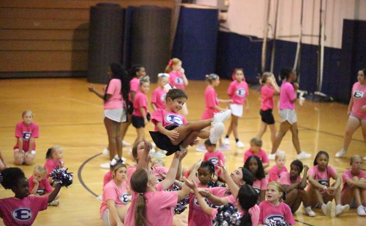 Ella Harrell is thrown through the air during cheer camp at Elbert County Comprehensive High School (ECCHS). A total of 82 future cheerleaders were in attendance for the camp put on by the ECCHS cheerleaders and coaches. (Photo by Bo Underwood)