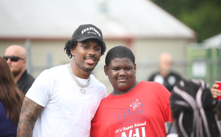 Mecole Hardman poses with a camper at last year's Friends Helping Friends Football Fun Day. (Photo by Mark Wells)