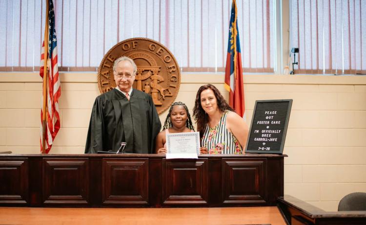 Judge Harvey Wasserman, Bree Carroll-Jave and Victoria Carroll-Jave pose for a picture in the courtroom on Bree’s adoption day. (Photo courtesy of Victoria Carroll-Jave)