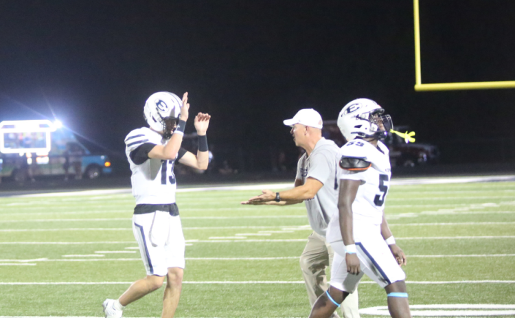 Quarterback Brody Baker and head coach Andy Dyer high-five following Elbert’s win over East Jackson. (Photo by Bo Underwood)