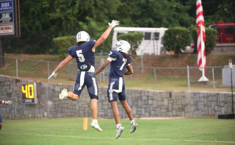 Zaylen Moon (7) celebrates his touchdown with Jackson Black (5). (Photo by Bo Underwood)