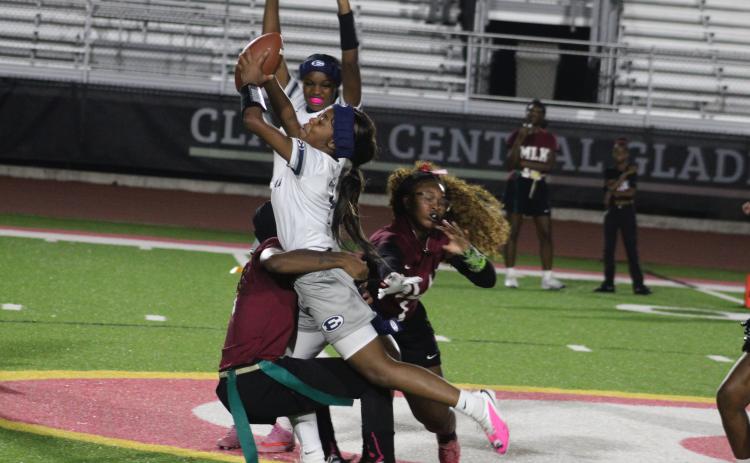Tiyah Turman absorbs more contact than usual for a flag game, but this big gain at midfield helped set up Elbert County’s first touchdown in its comeback against M.L. King.