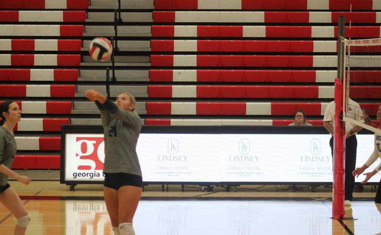 ECCHS' Isabella Adams sets for a teammate during the state tournament match with Morgan County.