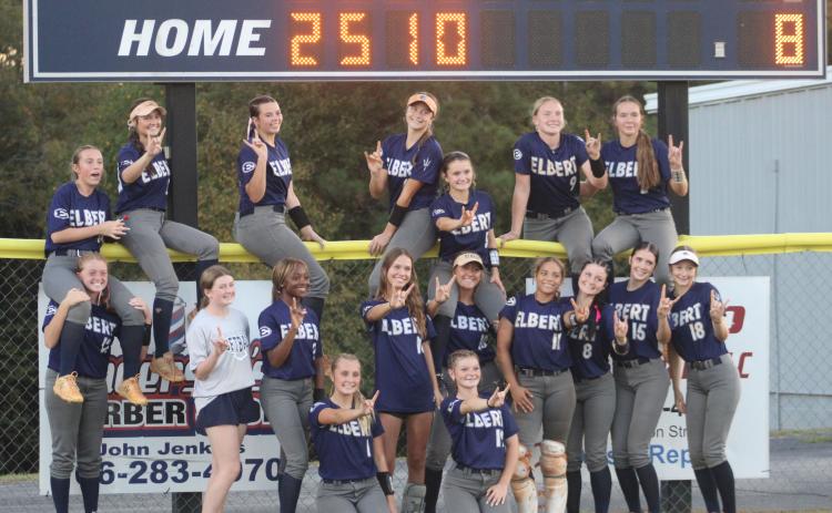 Lady Devils players pose in front of the scoreboard after shutting out Callaway to advance to the second round of state.
