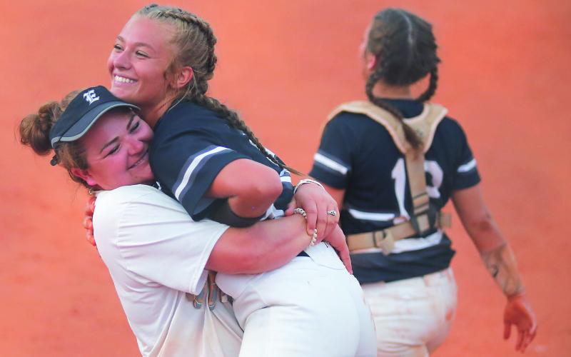 Lady Blue Devil assistant coach Katie Archer (left) and senior pitcher Lauren Hart react during Elbert County’s 11-1 victory at Clarke Central High School  Sept. 4 in Athens (Photo by Cary Best)