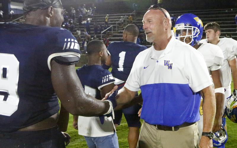 Washington-Wilkes offensive line coach and former Elbert County head coach Sid Fritts (right) shakes hands with senior Blue Devil Qwen Moss after Friday night’s game Aug. 30 in Elberton. (Photo by Cary Best) 