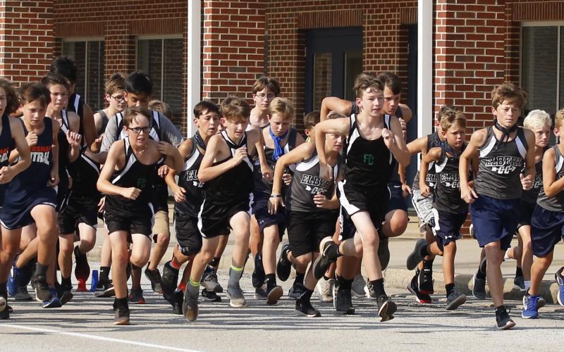 Rams runners (L-R) Mason Dove, Aiden Belli, Kale Kurtz, Brayden Ingram, Eli Harris, Sam Gailey, Madden Drake take off from the starting line in the first Elbert County Middle School Cross County meet Sept. 10. (Photo by Cary Best)