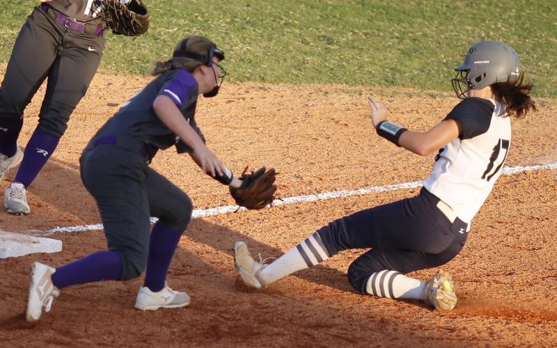 ady Blue Devil junior Madelyn Diaz (left) slides safely into third base during the sixth inning of Elbert County’s 2-1 loss to Union County Aug. 28 at King Field in Elberton. (Photo by Cary Best)