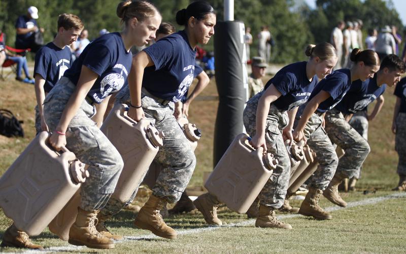 Elbert County JROTC Mixed Raiders team members (L-R) Makayla Ingle, Jamitel Bernier, Haylee Marunich, Maelynn Ruff and Thomas Vaughn   carry two 25-pound jugs in the water can relay in the Jackson County High School Raiders meet Sept. 21 in Jefferson. (Photo by Cary Best) 
