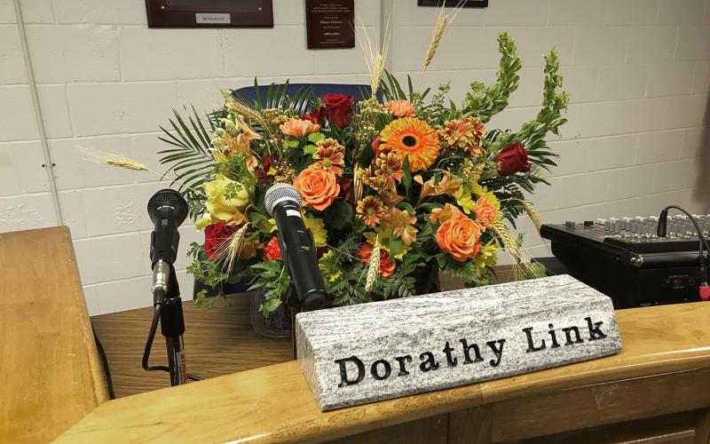Dorathy Link, an Elbert County School District Secretary, died in an accident last week in Hartwell. The school board paid tribute to Link Monday night at its regular meeting by placing flowers at the podium where she normally sits during school meetings. (Photo by Jones)