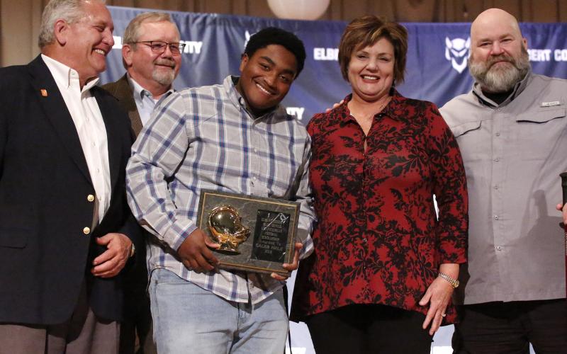 Blue Devil senior Caleb Hale (center) reacts as he accepts the 2019 L.C. Piccirillo Scholarship and Football Award during the Elbert County Athletic Department’s Fall Sports Awards Program Monday night Dec. 9 in the Elbert County Middle School Auditorium. Pictured with Hale (L-R) are Ciro Piccirillo, Ed Fendley, Nannette Piccirillo and Lenny Piccirillo. (Photo by Cary Best)