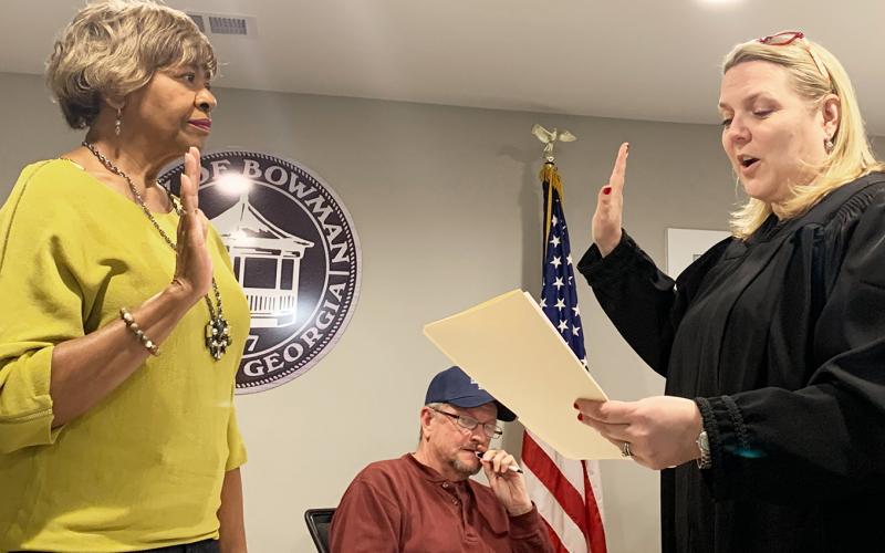 Stephanie Hewell (right) swears in Bowman council member Mary Clark. (Photo by Scoggins)
