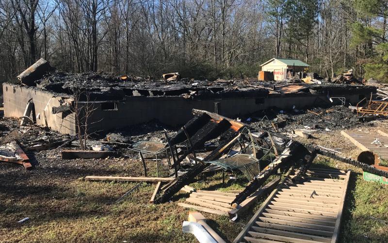 Elbert County firefighters and Sheriff’s Office deputies found this 1,320-square-foot structure “flattened and still burning” Thursday morning at 3:15 a.m., according to a news release issued by Sheriff Melvin Andrews. South Carolina Law Enforcement Division Public Information Officer Tommy Crosby said the owner of the home on Craft Road was ‘associated’ with a February 2019 murder of a paramedic in Anderson, South Carolina.
