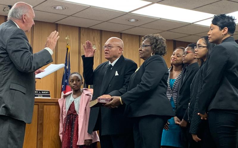 Terry Burton took his oath of office surrounded by his wife, two daughters and three grandchildren.