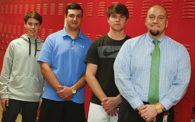 Jason Kouns (right) stands at ease with Elbert County Comprehensive High School students (L-R) Slate Crook, Eli Goff and Brady Starrett. (Photo by Best)