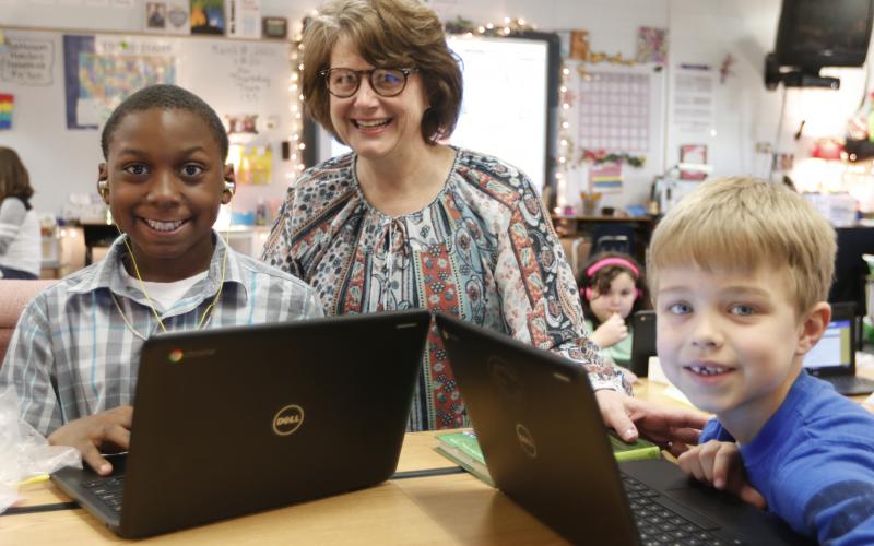 Elbert County Elementary School Principal Stephanie Wiles checks out the work of students Ethan Watkins (left) and Levi Wiles (right) on computers at the school recently. (Photo by Scoggins)