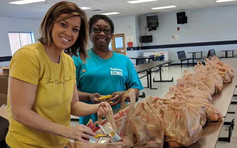 Tina Hudson, School Nutrition Coordinator, and Doris Allen, School Nutrition Assistant, pack bags for the Elbert County School System’s ‘Grab and Go’ lunch program.