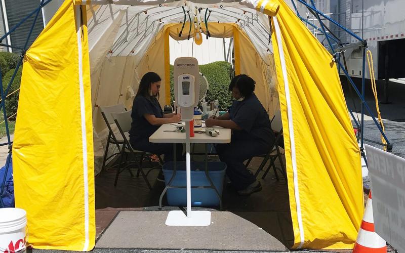 Andrea Webb (left) and Margie Rucker are screening all persons entering Elbert Memorial Hospital in a tent outside of the hospital’s emergency room. (Photo by Jones) 