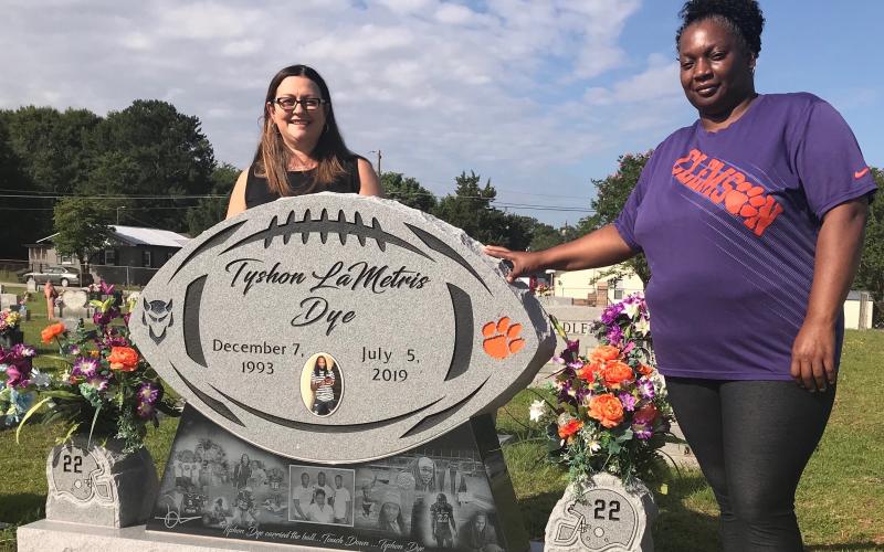 Angie Bonds (left) and Peggy Dye recently visited Lincoln Heights Cemetery to talk about the unique monument created to honor the memory of Peggy’s son, Tyshon Dye. (Photo by Jones)