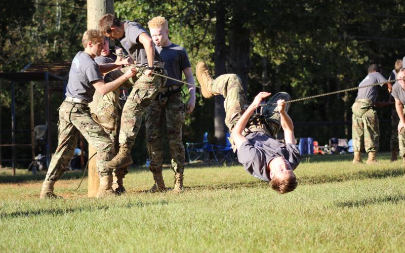 Justin Bastyr is in a world turned upside down during rope bridge competition at Hart County High School. Shown on the ropes behind Bastyr are (L-R) Brandon Nestor, Thomas Vaughn, Gabriel Pless and Jordan Teasley.