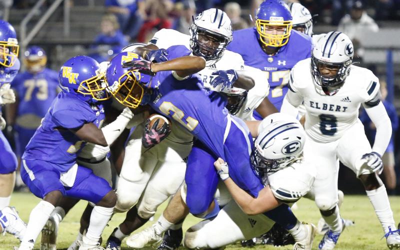 Elbert County’s defense hangs on to Washington-Wilkes running back Quinshawn Hearst Friday night in Washington. The Tigers took control of Friday’s contest early then coasted to a 42-7 victory over the Blue Devils. (Photo by Scoggins)