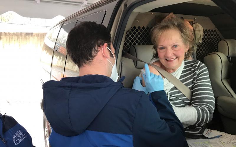 Kathy Pfaender of Hartwell gets a vaccine from Athens Tech nursing student Alex Higgins at EMH’s drive-through Monday morning. (Photo by Jones)