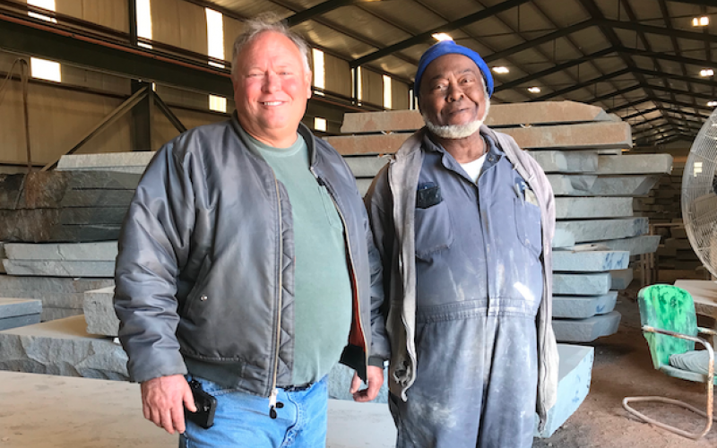 Mark Hill stands with Hillcrest Granite’s first employee, Clark Rucker, who was hired by the fledgling granite company back in 1979, when Mark and his father, Calvin, started the business. (Photo by Jones)