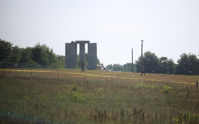 An agent from the Georgia Bureau of Investigation surveys the scene at the Georgia Guidestones early Wednesday morning after an explosion damaged the monument, leaving one of the slabs in a pile of rubble. (Photo by Scoggins)