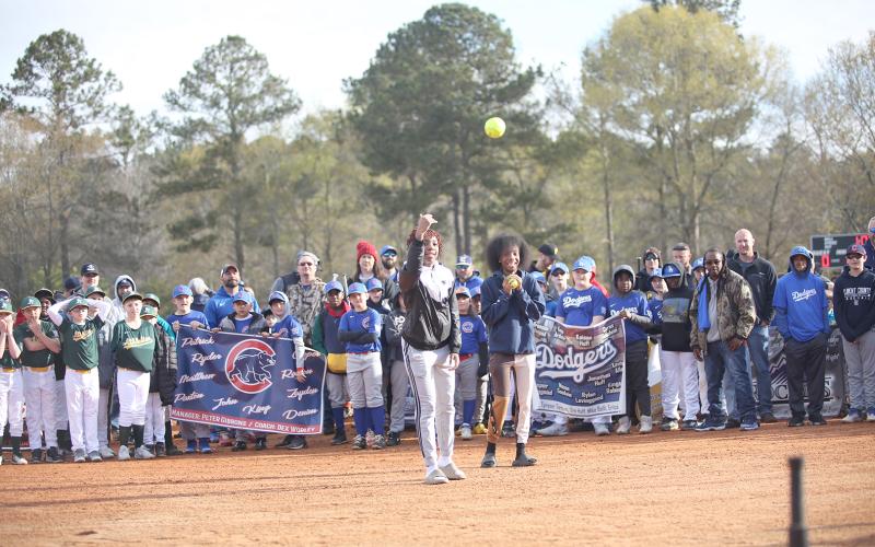 A parade of teams and coaches began the day, followed by a ceremonial “first pitch” by Elbert County Lady Devil 2022 state champions (L-R) Aaniyah Allen and Niya Moon. Lady Devils Hannah Brady and Emily Booth served as catchers. (Photo by Wells)