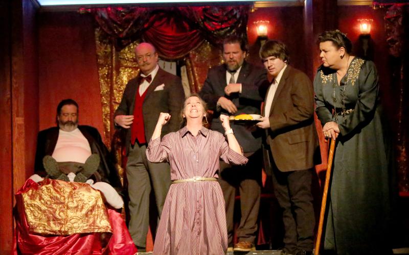 Tracy Bennett (front) as “Greta Ohlsson” drops to her knees in agony after a murder is discovered as part of the Elbert Theatre’s upcoming production of Agatha Christie’s “Murder on the Orient Express.” Also pictured are (back row, L-R) Robert Roach as “Samuel Ratchett,” Michael Weis as “Hercule Poirot,” Philip Hiott as “Monsieur Bouc,” Jake Triplett as “Hector MacQueen” and Jennifer White as “Princess Dragomiroff.” (Photo by Wells)