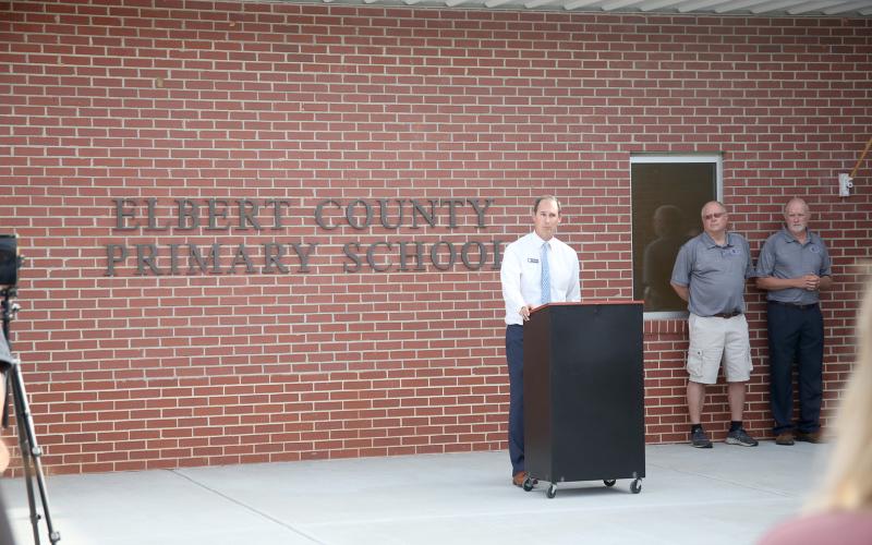 Superintendent Robert Wheeler address the crowd during the ribbon cutting with the new ECPS signage on the wall. (Photos by Wells)
