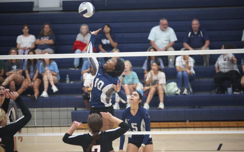 America Vargas (No. 5) watches as Keitasia Glaze (No. 10) leaps to spike a ball in Elbert County’s 2-0 loss to Rabun Aug. 17. The Volley Devils are 3-7 so far on the season with wins over Monsignor Donovan, Washington-Wilkes and Cedar Shoals. (Photo by Wells)