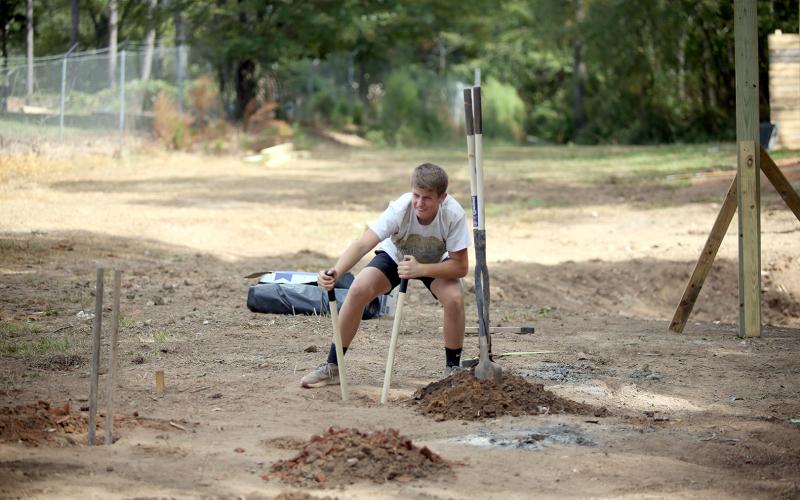 Wyatt Stelter digging holes for posts for the new obstacle course. (Photo by Wells)