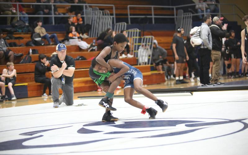 Denim Watts attempts a double leg takedown during an exhibition match against Youth Middle School Nov. 29. (Photo by Wells)