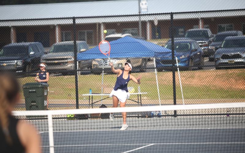 Myla Warwick serves the ball during her win in the girls No. 1 doubles match against Hart County March 21. (Photo by Wells)
