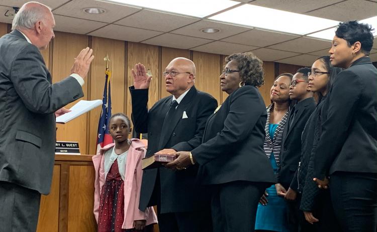 Terry Burton took his oath of office surrounded by his wife, two daughters and three grandchildren.