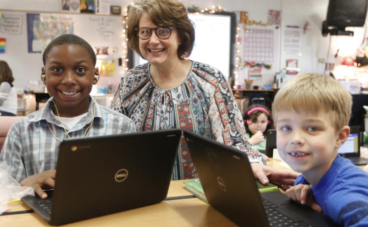 Elbert County Elementary School Principal Stephanie Wiles checks out the work of students Ethan Watkins (left) and Levi Wiles (right) on computers at the school recently. (Photo by Scoggins)