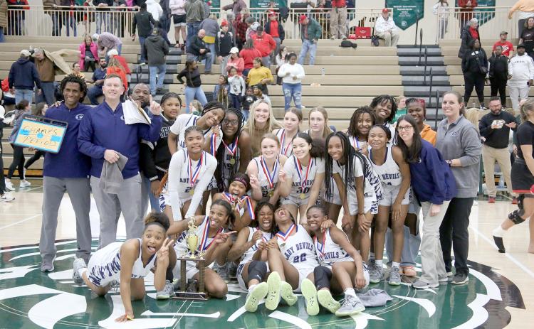 The Elbert County Lady Devils claimed the Region 8A-D1 championship trophy after defeating Rabun County 61-41 in the region tournament Feb. 17 at Piedmont University. The win came nearly one year after the Lady Devils lost the championship to the Lady Cats before ultimately defeating Rabun in the GHSA state championship. (Photo by Scoggins) 