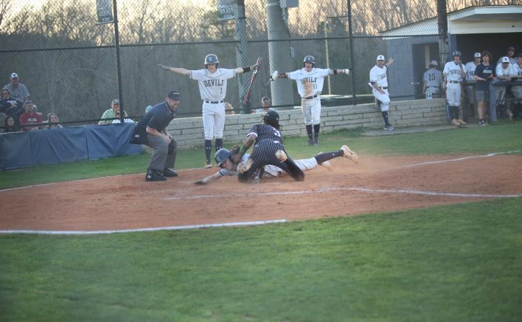 Devils (L-R) Eli Harris and Skylar Bray call Brooks Banks’ slide into home plate safe during the Devils’ 7-6 win over Tallulah Falls March 9 at Diamond Devil Field. (Photo by Wells)