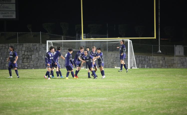 A host of Blue Devils celebrate with Juan Martinez after he scored a goal against Tallulah Falls Thursday, March 9 in the Granite Bowl.
